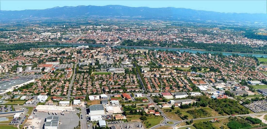 A view of the town of Guilherand-Granges, the banks of the River Rhône, and Valence in the Drôme in the background on the opposite bank