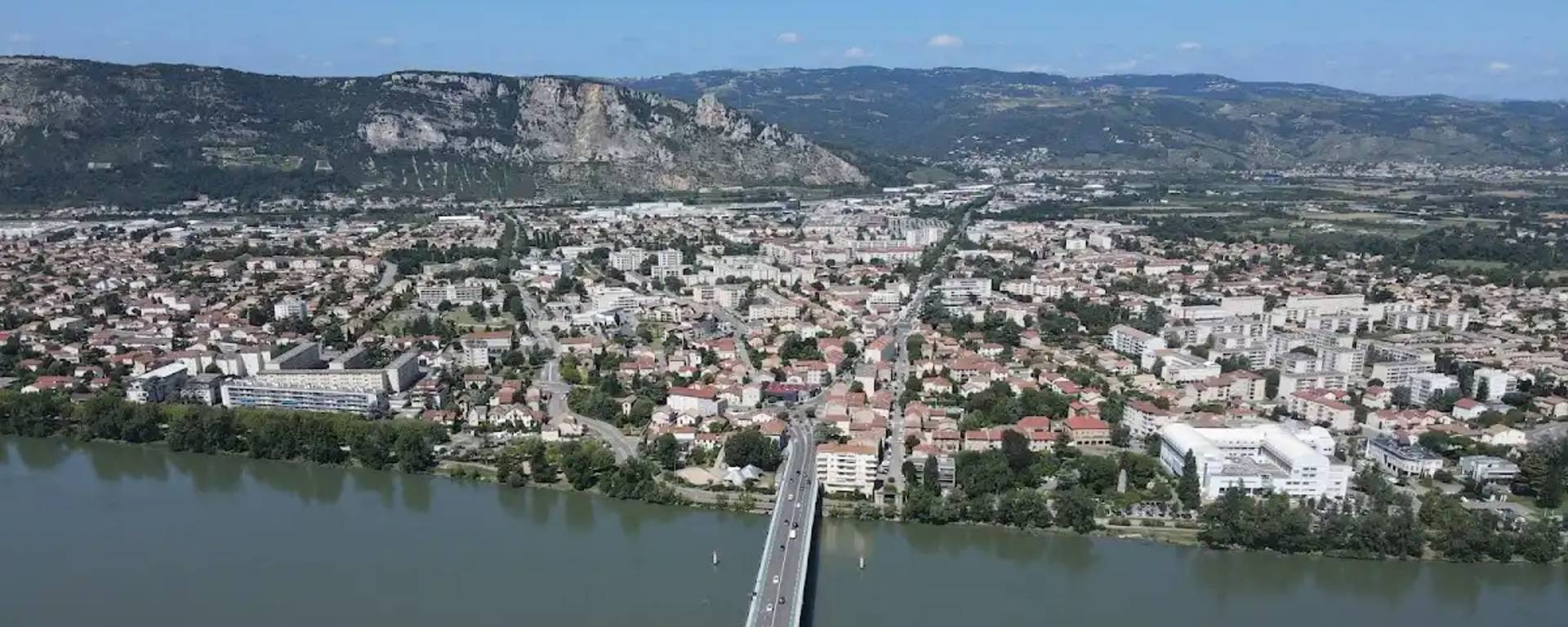 Aerial view of the village of Guilherand-Granges in the Ardèche, with Crussol Castle in the background