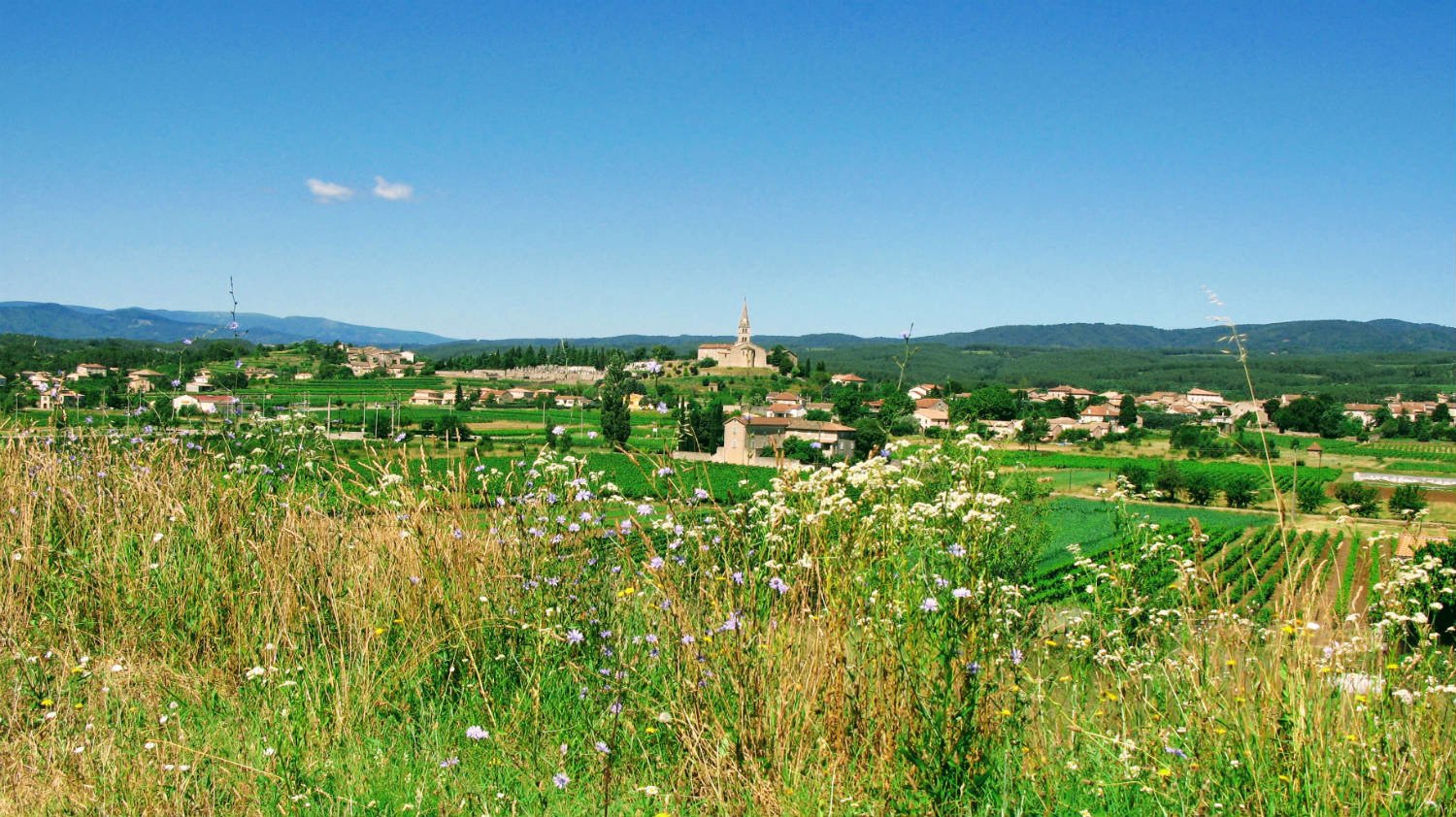 View of Lablachère in the Ardèche and the village centre, with the mountains in the background