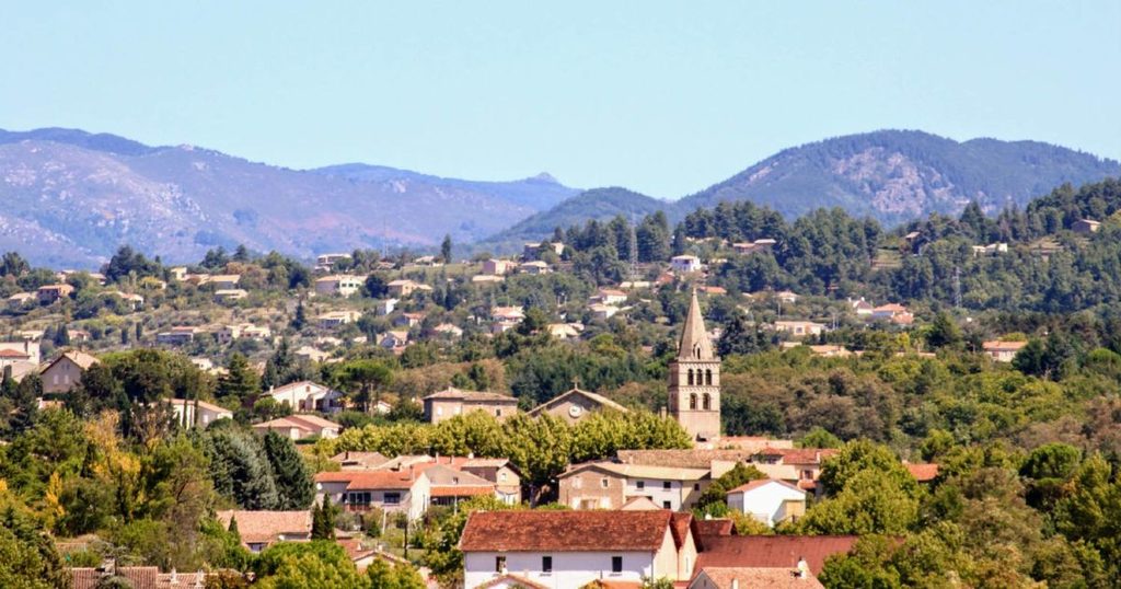 Vue sur le centre ville de Saint-Etienne-de-Fontbellon sur fond de montagne ardéchoise